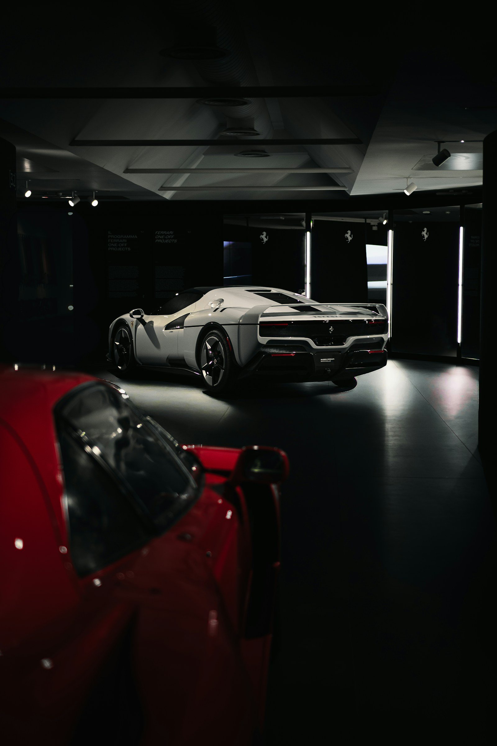 Luxury cars in a dark showroom