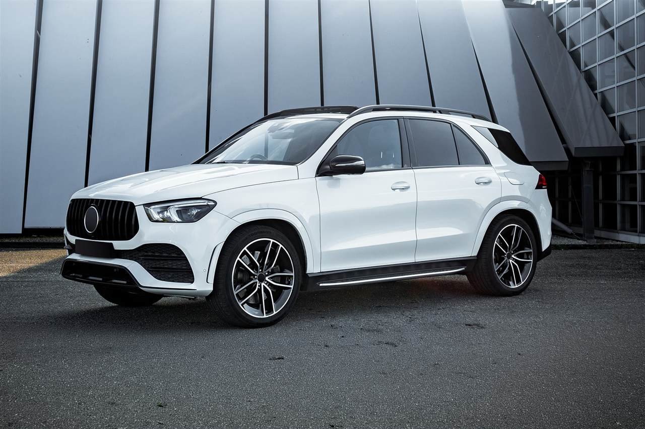 White Mercedes SUV outside a modern building